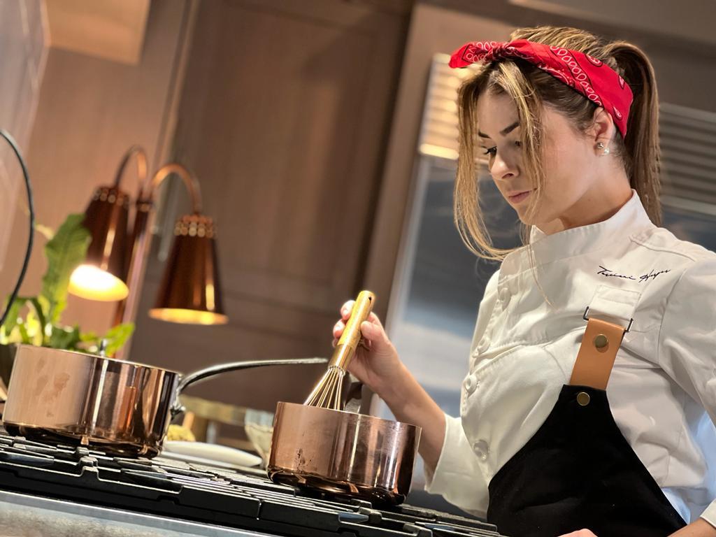 Chef Tarciani Harger working with copper pots